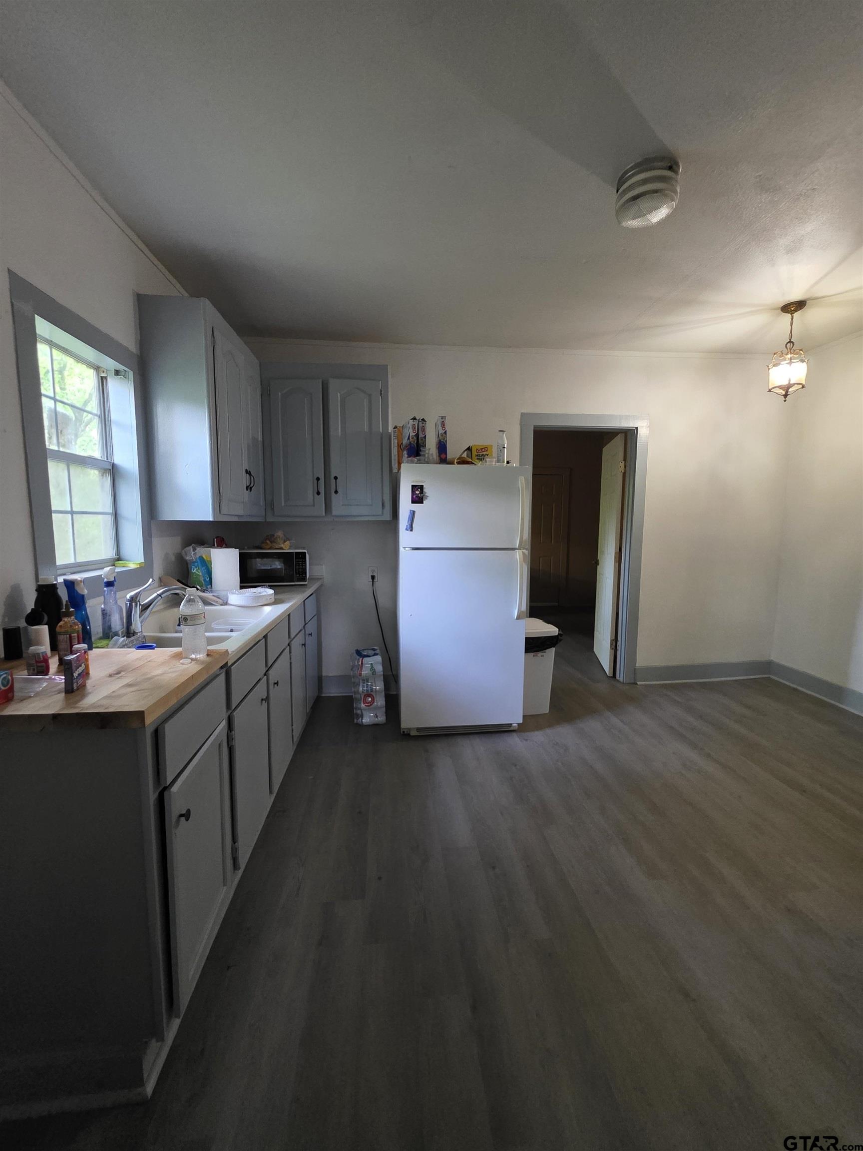 316 North Hospital Street Rusk, TX 75785 - Photo 13 of 21 a kitchen with sink refrigerator and cabinets