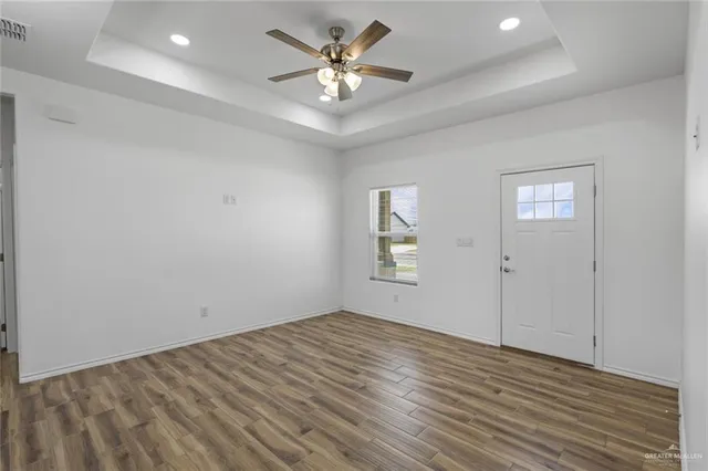 wooden floor in an empty room with a window