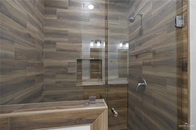 a bathroom with a shower and a sink