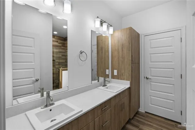 a bathroom with a sink double vanity and a mirror