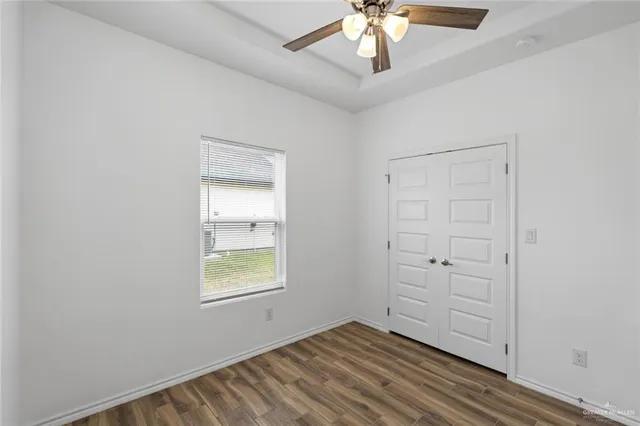 an empty room with windows and closet