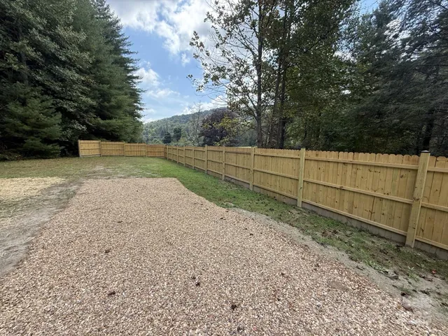 a view of a backyard with trees