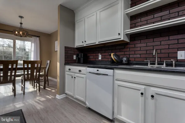 a kitchen with stainless steel appliances kitchen island granite countertop a stove a sink and a microwave