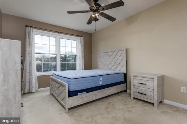 a bed room with a bed and a window