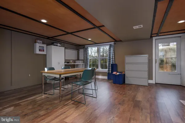 a sitting area with furniture and wooden floor