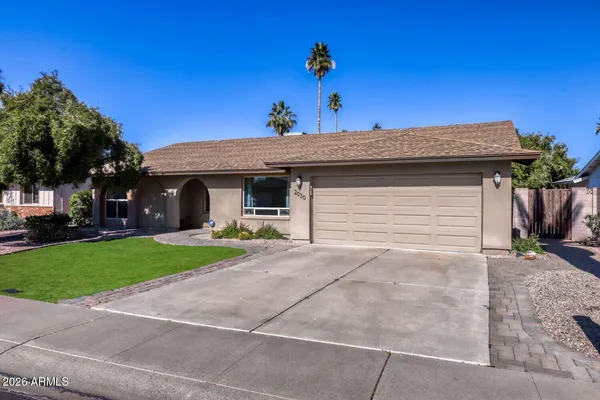 a front view of a house with a yard and a garage