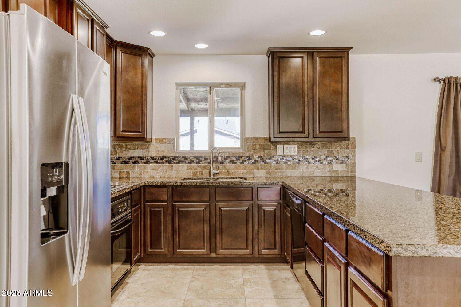 2030 East Colgate Drive Tempe, AZ 85283 - Photo 11 of 26 a kitchen with stainless steel appliances granite countertop a refrigerator and a sink