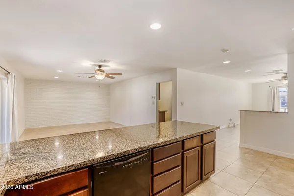 a view of a kitchen with a sink and chandelier