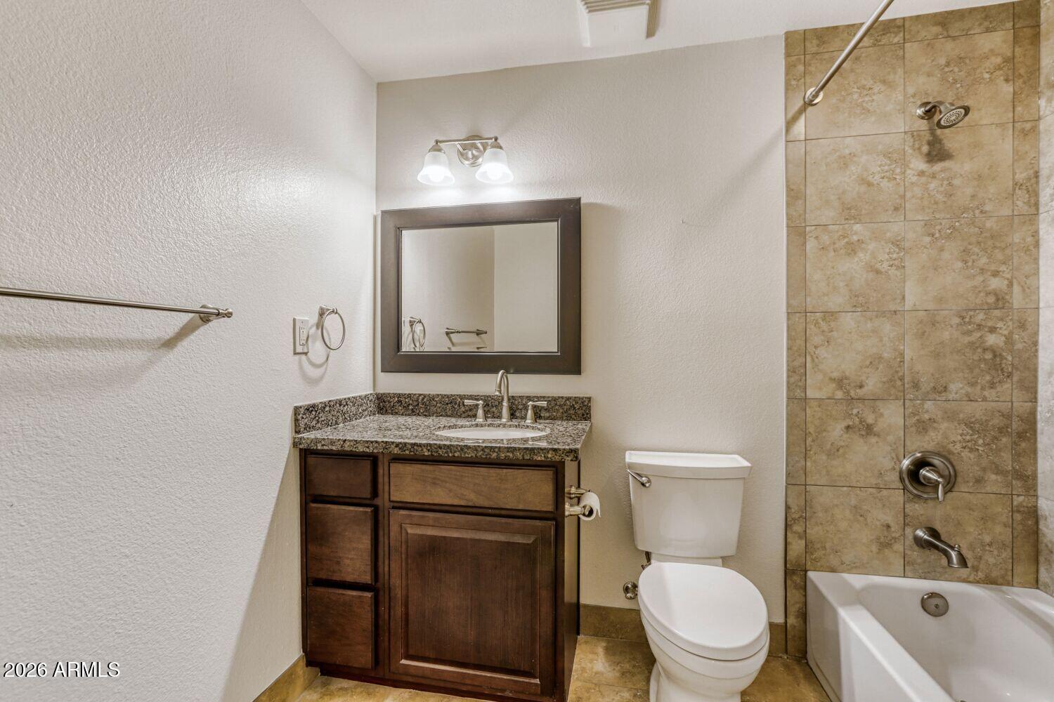 2030 East Colgate Drive Tempe, AZ 85283 - Photo 18 of 26 a bathroom with a granite countertop toilet a sink and a bathtub