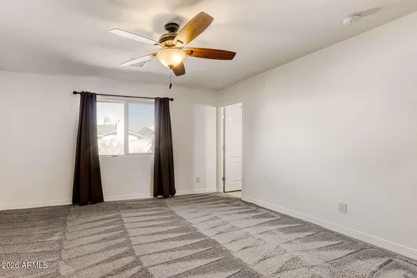 a bathroom with a granite countertop sink a toilet a mirror and shower