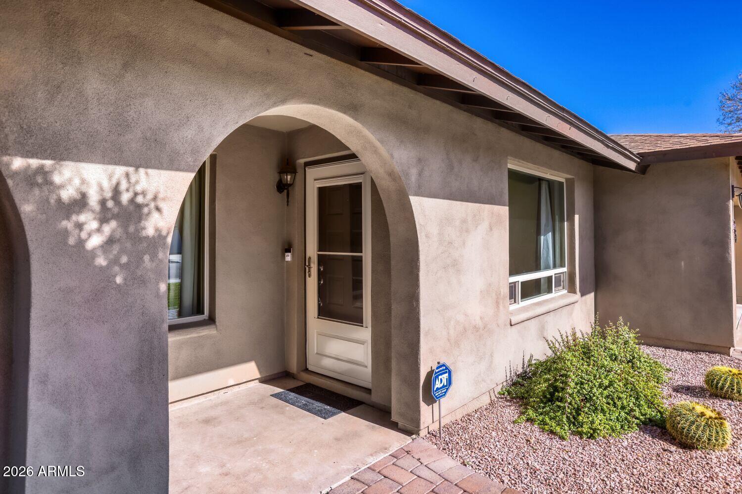 2030 East Colgate Drive Tempe, AZ 85283 - Photo 4 of 26 a front view of a house with a garden