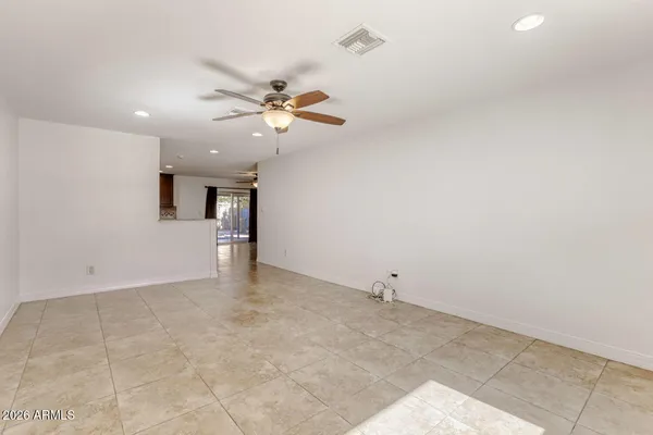 a view of a big room with wooden cabinets and windows