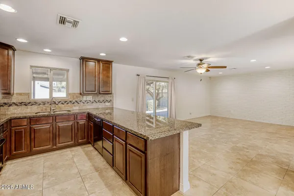 a kitchen with stainless steel appliances granite countertop a sink counter space cabinets and a view of counter top