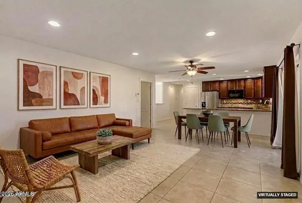 a living room with furniture and kitchen view