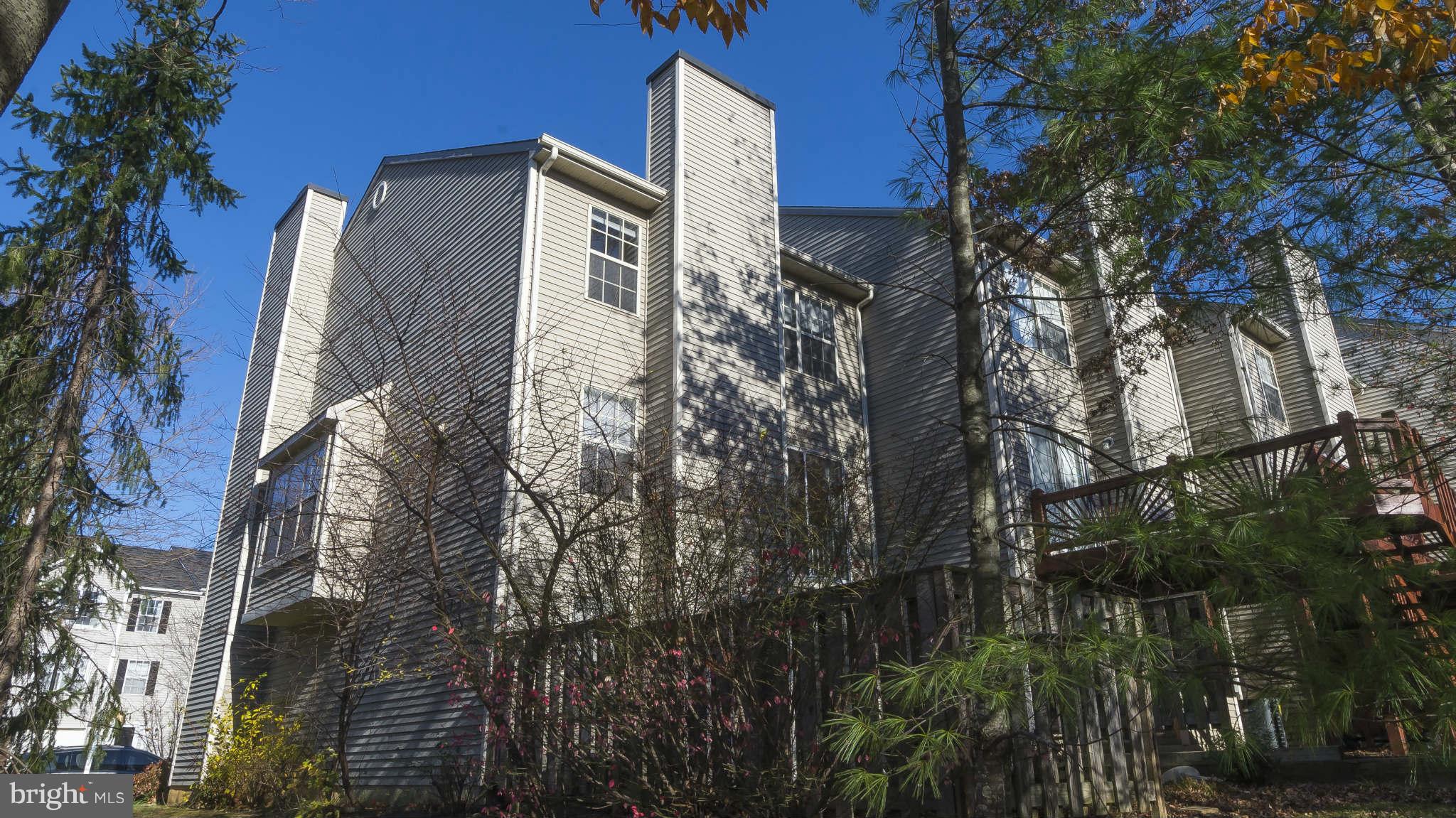 12200 Bare Bush Path Columbia, MD 21044 - Photo 29 of 30 a front view of a residential apartment building with a yard
