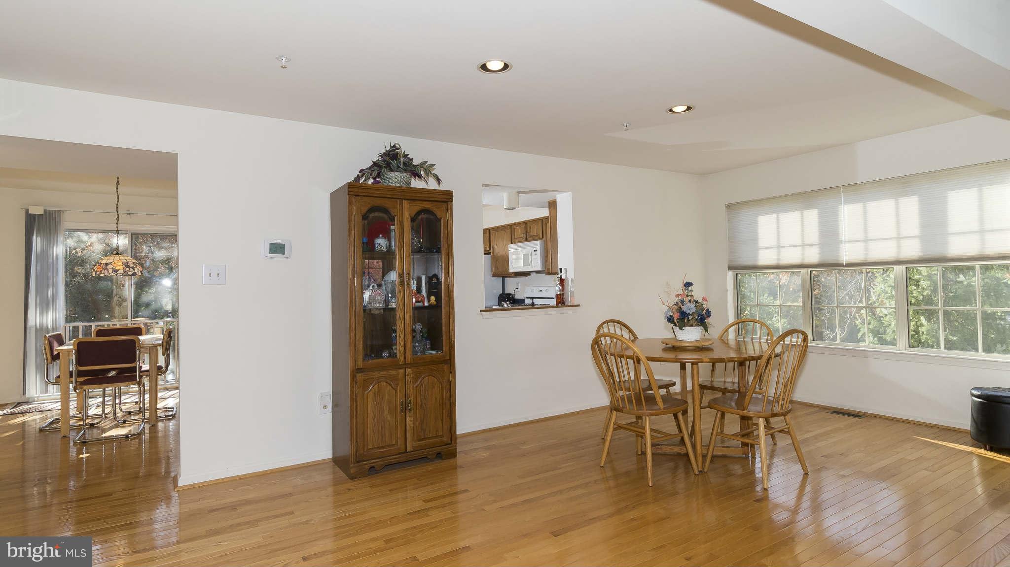 12200 Bare Bush Path Columbia, MD 21044 - Photo 6 of 30 a view of a dining room with furniture and wooden floor
