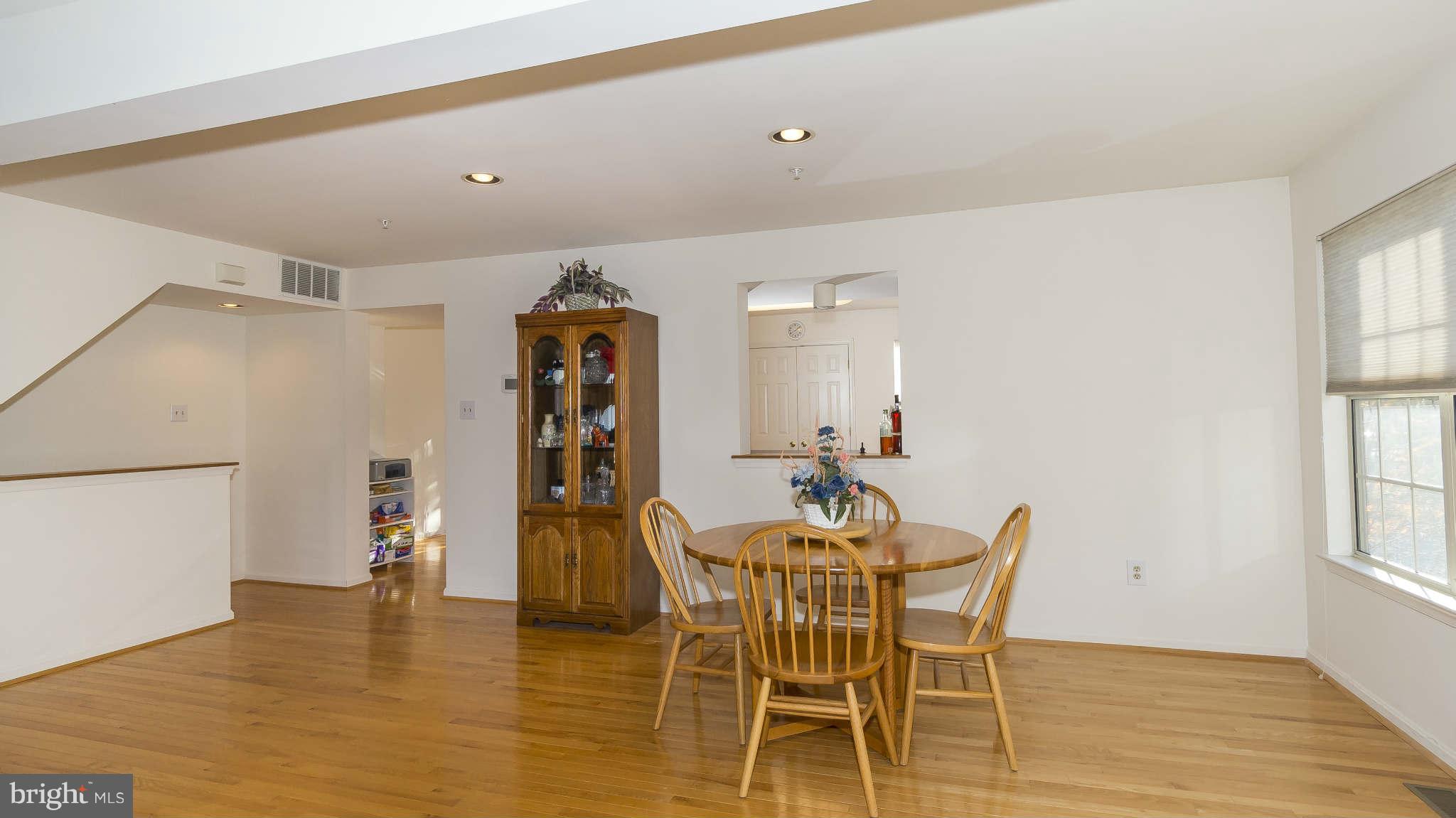 12200 Bare Bush Path Columbia, MD 21044 - Photo 7 of 30 a dining room with furniture and wooden floor