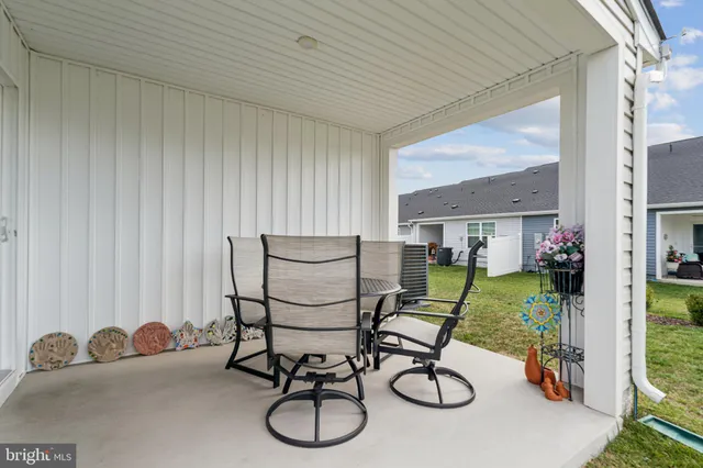 a view of a livingroom with furniture and a floor to ceiling window