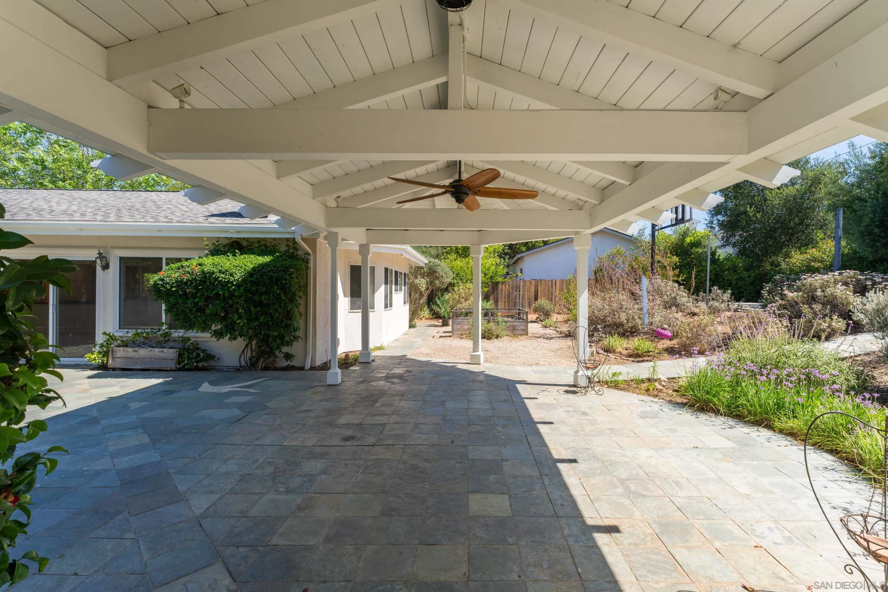 16611 Orchard Bend Road Poway, CA 92064 - Photo 43 of 59 a view of a patio with a table and chairs under an umbrella