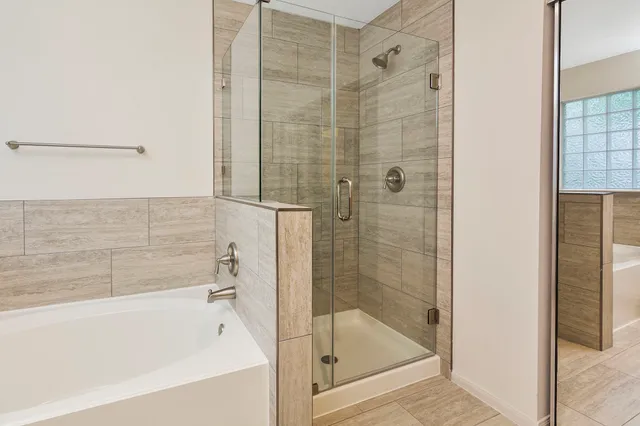 a bathroom with a bathtub and shower