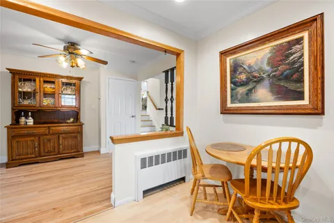 a view of living room kitchen with furniture and a ceiling fan