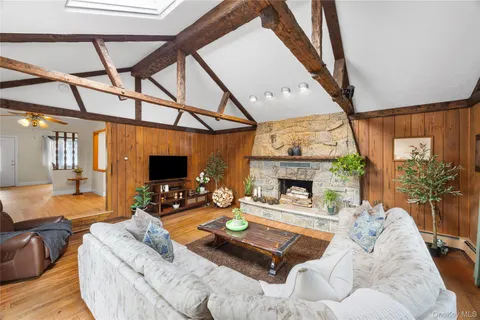 a living room with furniture a fireplace and a flat screen tv