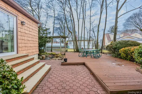a view of a backyard with table and chairs and potted plants