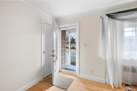 a view of a dining room with furniture and a window