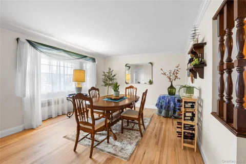 a view of a dining room with furniture and a potted plant