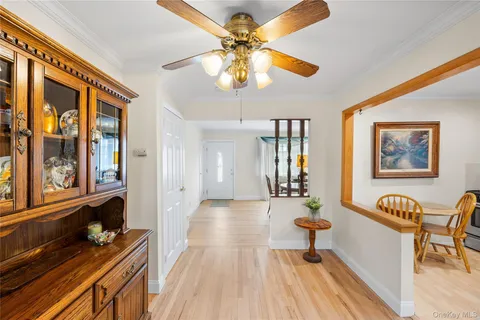 a kitchen with stainless steel appliances granite countertop a stove a sink dishwasher a refrigerator and wooden cabinets with wooden floor