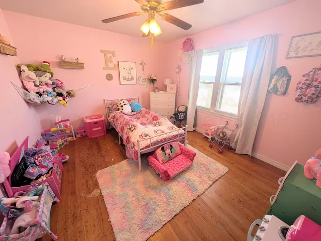 a bedroom with furniture and a window