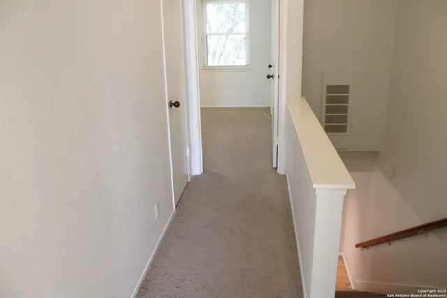 a view of a hallway with staircase