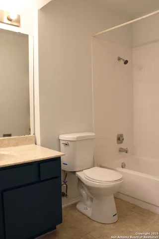 a white toilet sitting next to a bathroom sink