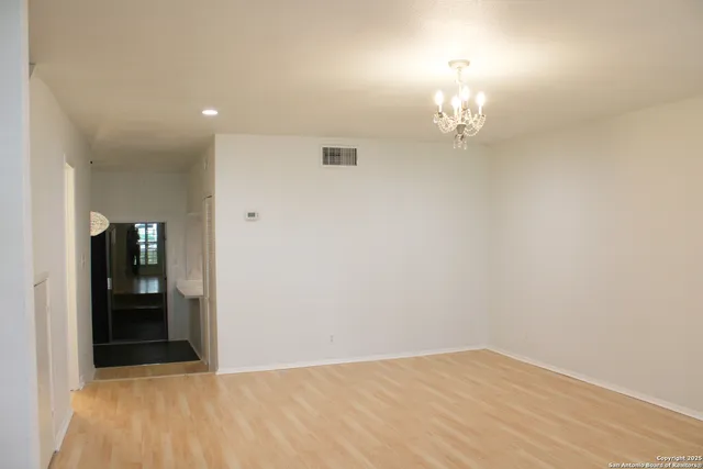 wooden floor in an empty room with a mirror