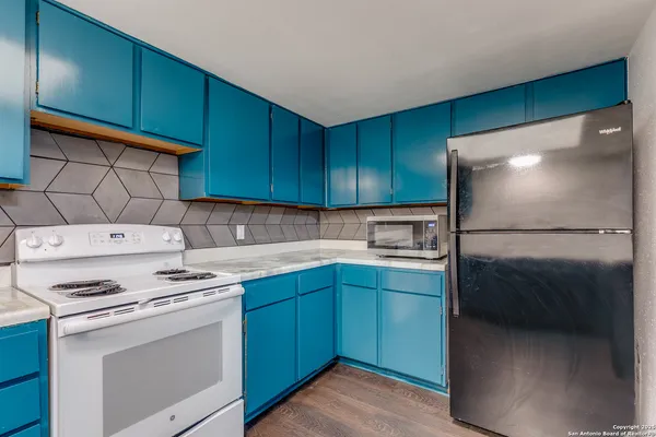 a kitchen with a cabinets and white stainless steel appliances