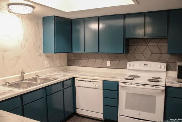 a kitchen with a sink cabinets and appliances