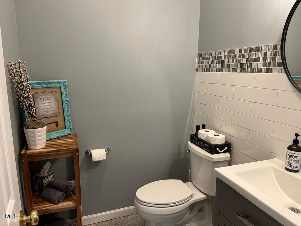 103 Summerglow Court Cary, NC 27513 - Photo 11 of 67 a bathroom with a toilet a sink and mirror