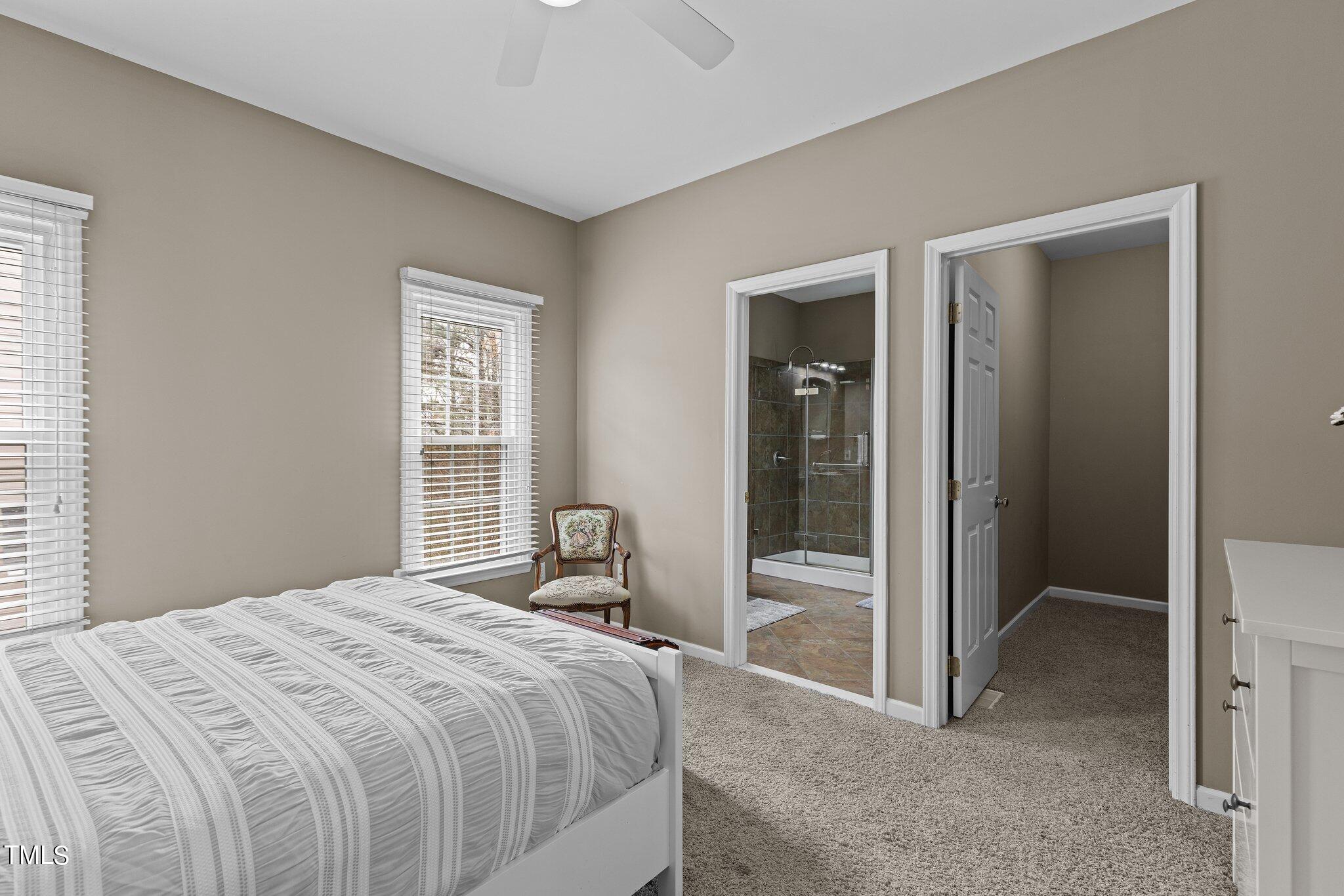 103 Summerglow Court Cary, NC 27513 - Photo 14 of 67 a bedroom with a bed and a mirror