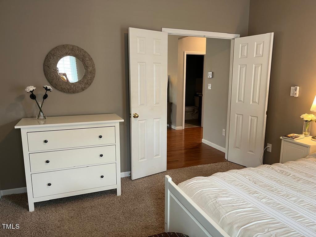 103 Summerglow Court Cary, NC 27513 - Photo 15 of 67 a bedroom with a bed and a dresser