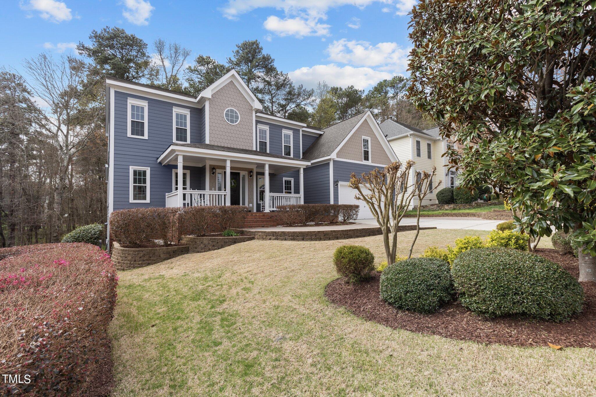 103 Summerglow Court Cary, NC 27513 - Photo 2 of 67 a front view of a house with a yard