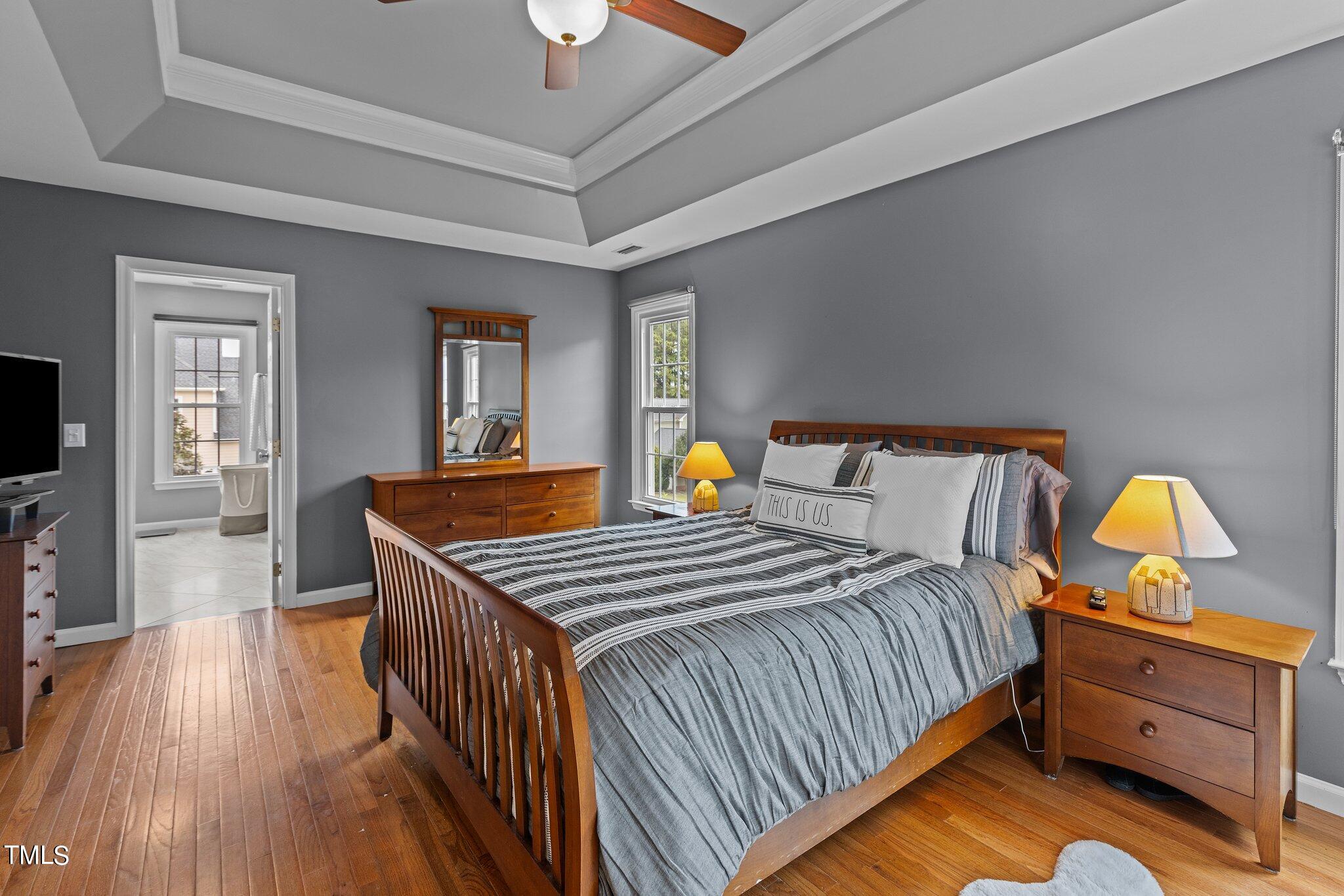 103 Summerglow Court Cary, NC 27513 - Photo 28 of 67 a bedroom with bed and wooden floor