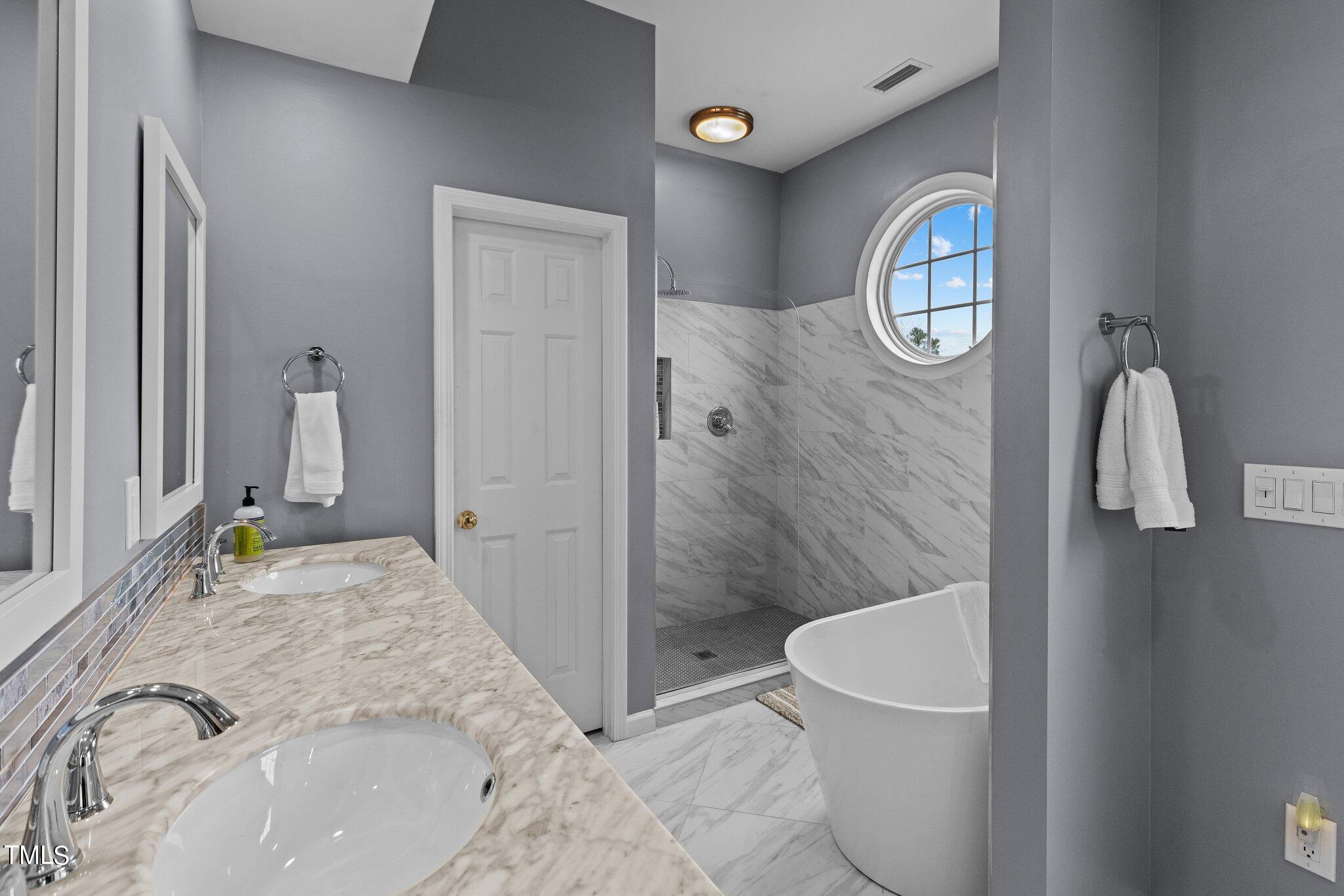 103 Summerglow Court Cary, NC 27513 - Photo 30 of 67 a bathroom with a granite countertop sink and a mirror