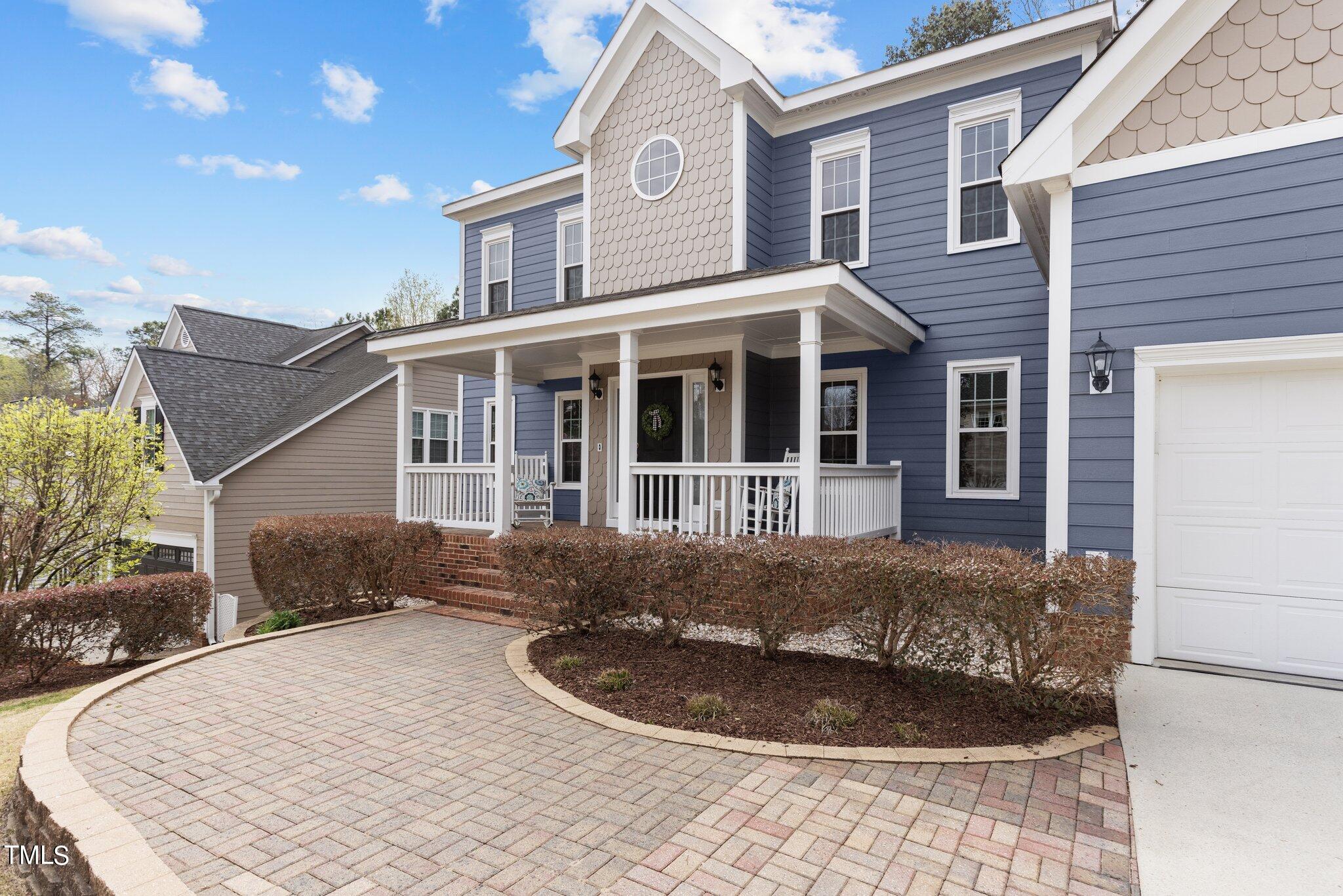 103 Summerglow Court Cary, NC 27513 - Photo 3 of 67 a front view of a house with a yard and garage
