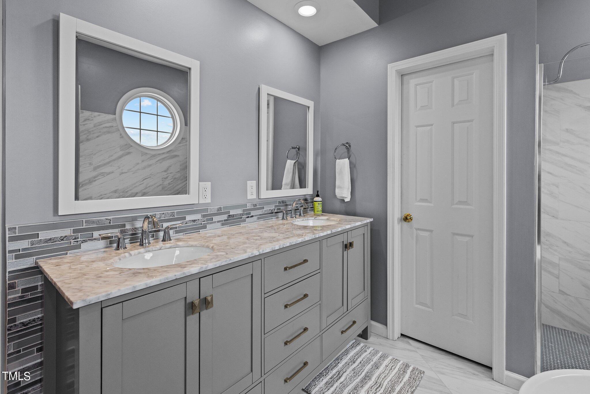 103 Summerglow Court Cary, NC 27513 - Photo 31 of 67 a bathroom with a granite countertop sink vanity and a mirror