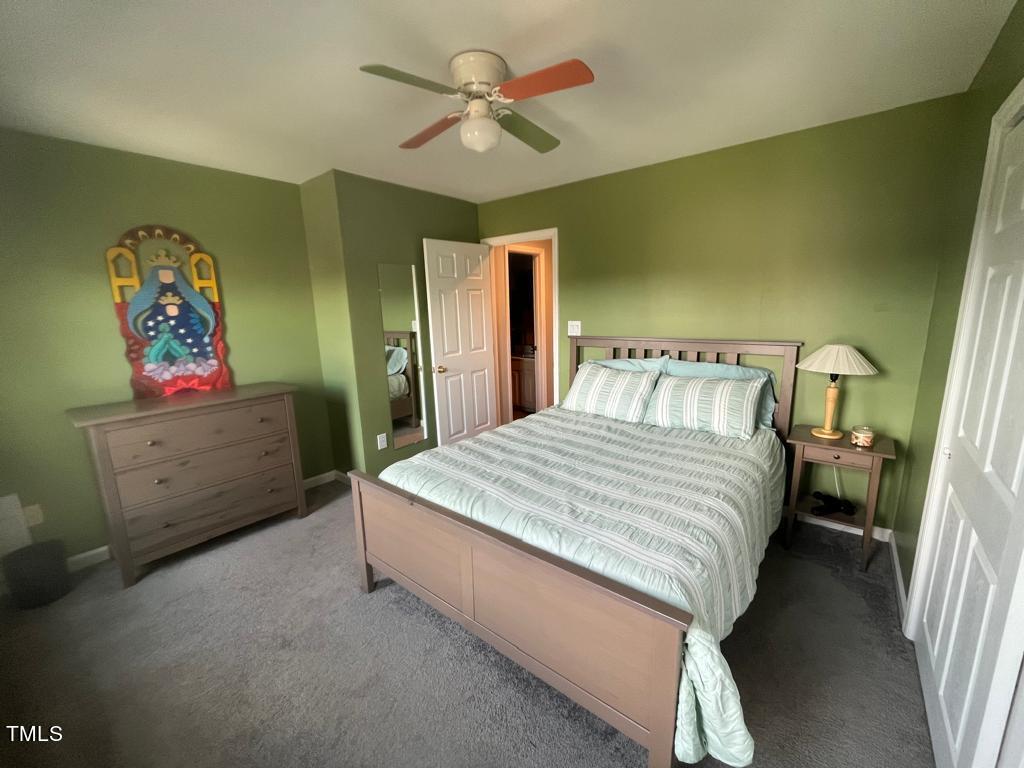 103 Summerglow Court Cary, NC 27513 - Photo 36 of 67 a bedroom with a bed and a chandelier