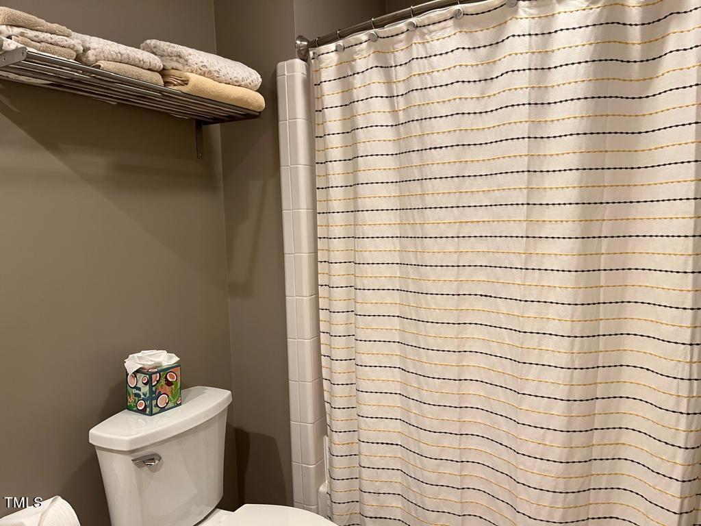 103 Summerglow Court Cary, NC 27513 - Photo 38 of 67 a bathroom with a sink a toilet and a mirror