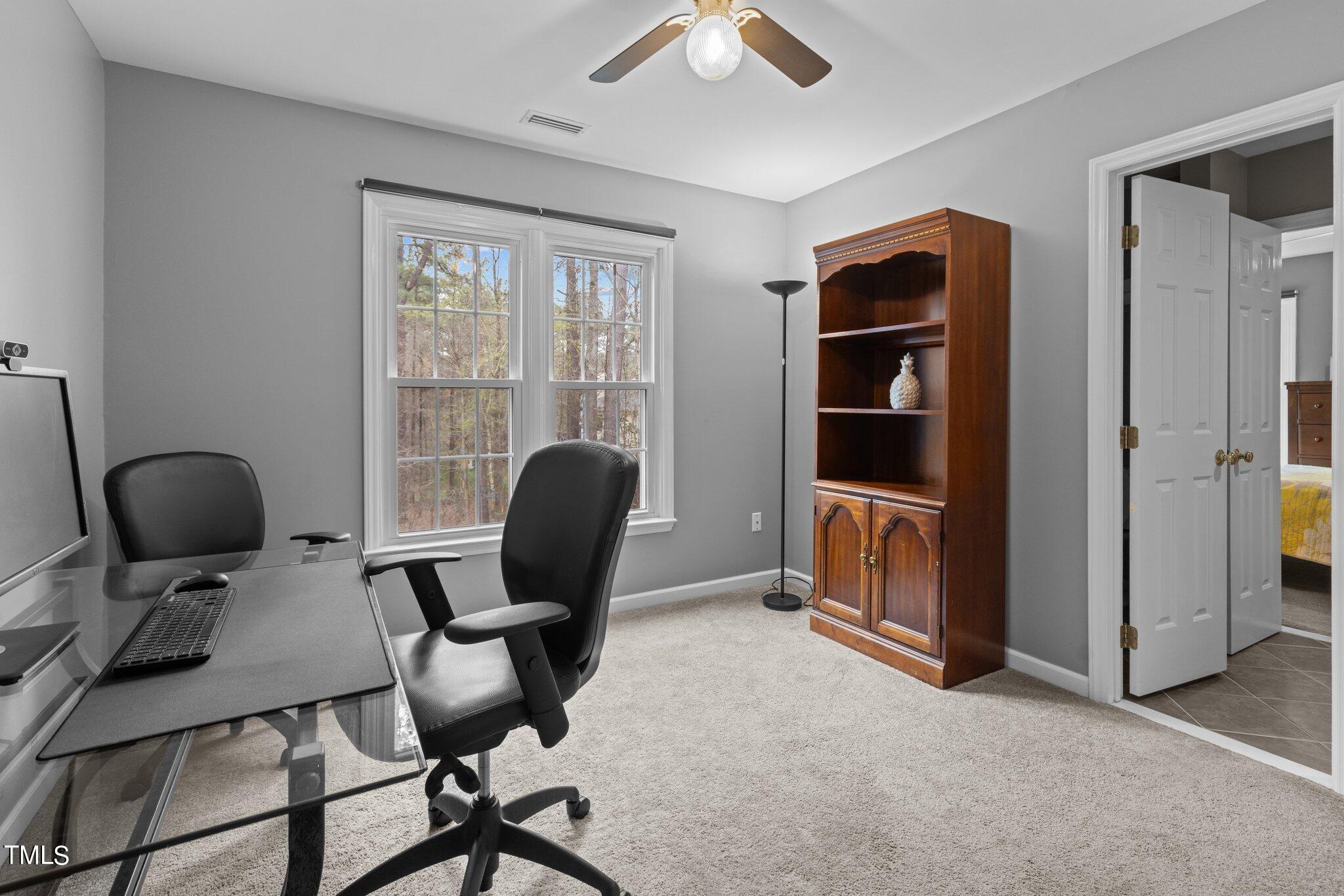 103 Summerglow Court Cary, NC 27513 - Photo 39 of 67 a view of a workspace with furniture and a window