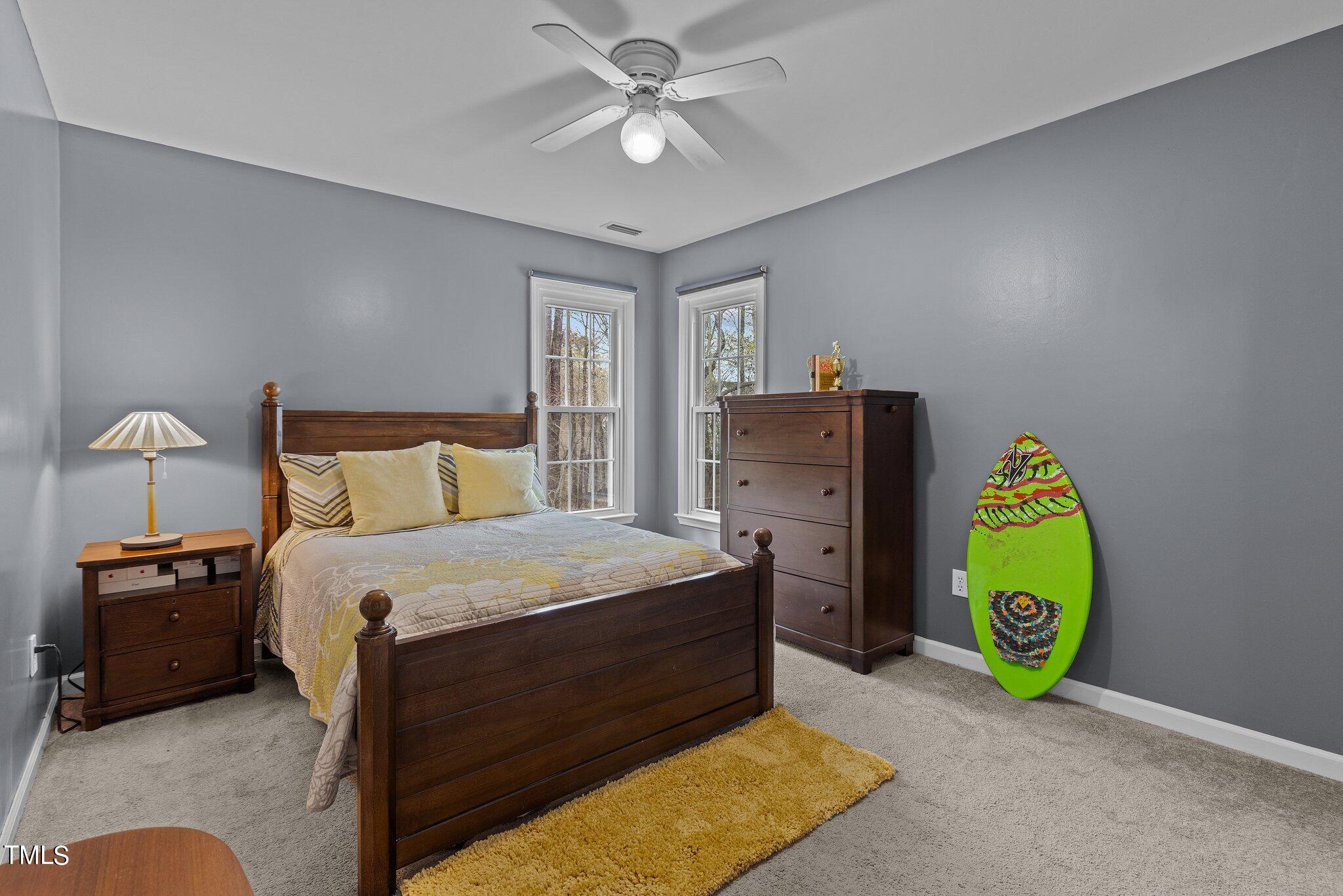103 Summerglow Court Cary, NC 27513 - Photo 40 of 67 a bedroom with a bed and a chandelier