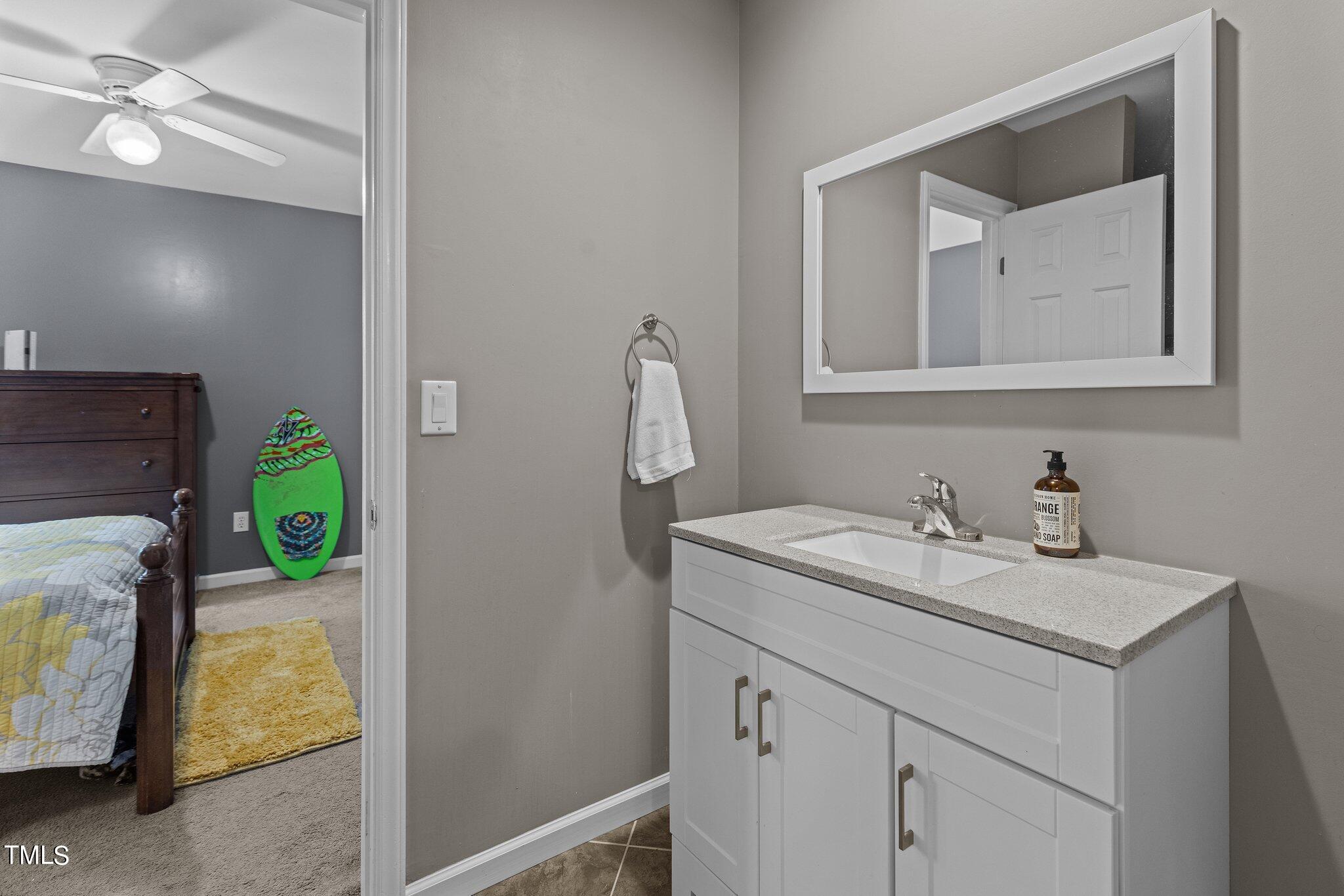 103 Summerglow Court Cary, NC 27513 - Photo 41 of 67 a bathroom with a sink and a mirror