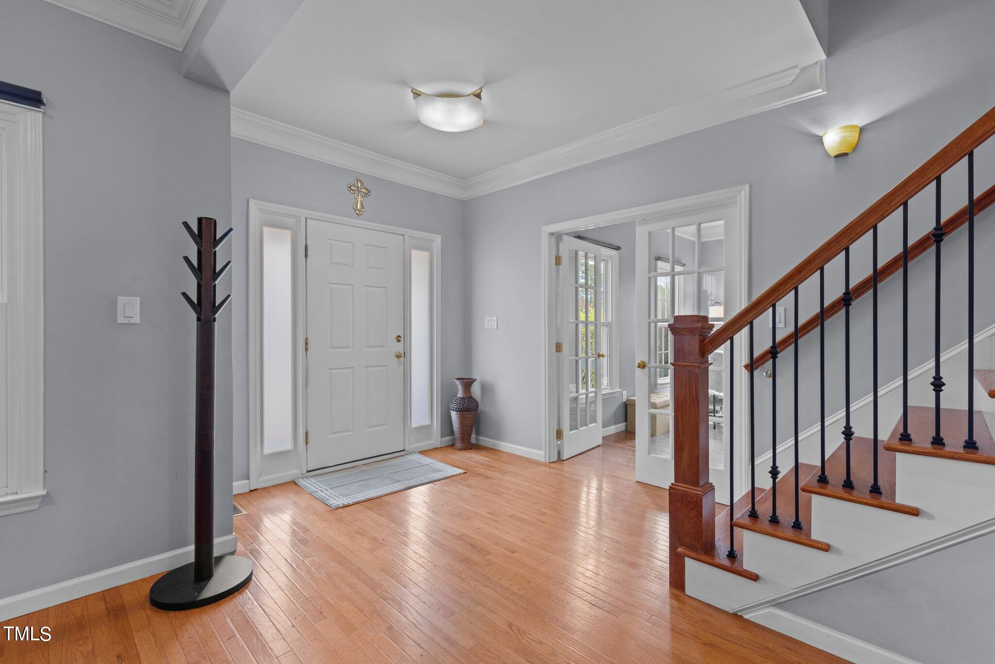 103 Summerglow Court Cary, NC 27513 - Photo 6 of 67 a view of entryway with wooden floor